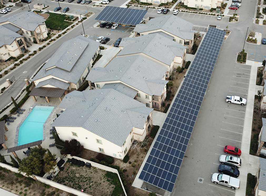 Multifamily apartment covered carport solar structure and energy system.