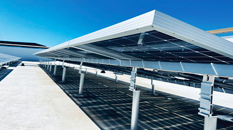 Rooftop solar and commercial PV mounted pv energy system installed on top of a commercial retail shopping center.
