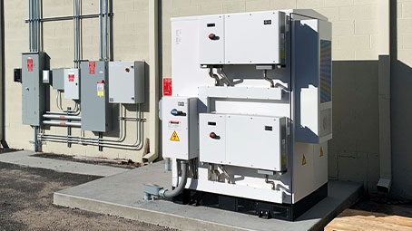 battery energy storage system installed near the wall of a commercial building.